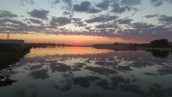 Flying on a river in a sunrise. Ocean in a background.