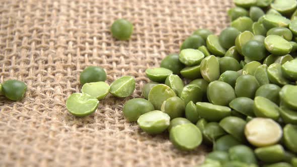 Green peas on a rustic sackcloth. Dry uncooked legumes on burlap