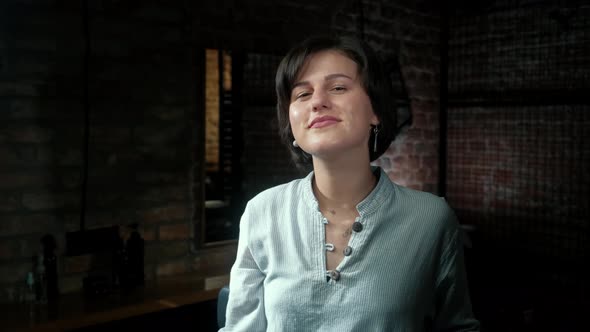 Portrait of Smiling Beautiful Woman Hairdresser Looking at Camera While Holding Professional