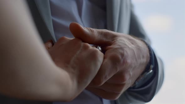 Lovely Couple Hands Connecting in Cloudy Sky Background