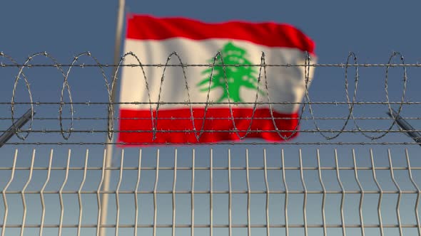 Barbed Wire Against Waving Flag of Lebanon