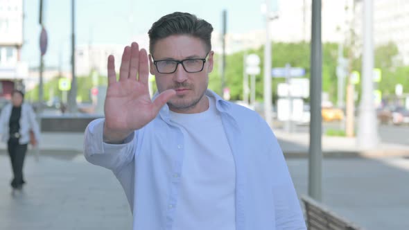 Stressed Man Showing Stop Gesture Outdoor