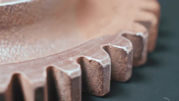 Metal Teeth of a Rotating Gear on a Dark Background in Closeup