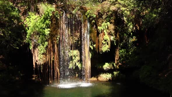 Footage of a small waterfall with a clear blue plunge pool in the Blyde River canyon Gorge on the Pa