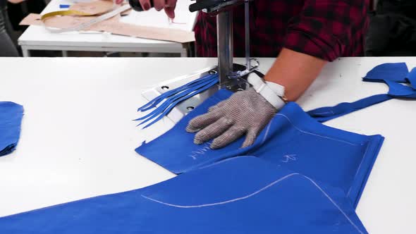 Female Working in a Textile Factory Cutting Cloth