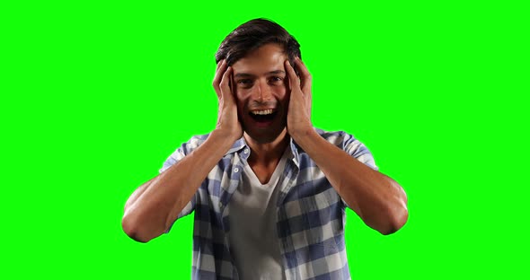 Front view of Caucasian man surprising with green screen