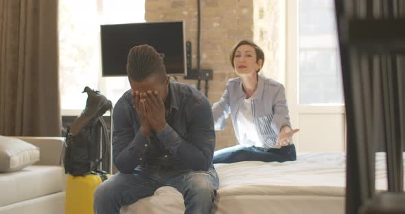 Angry Beautiful Caucasian Woman Yelling and Gesturing at the Background As Tired Bored African