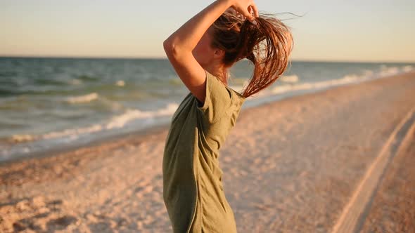 Sensual Young Woman on Beach Hair Fluttering in the Wind Sea