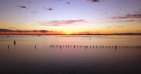 Sunset Light Reflects on Sea Water with Shellfish Farm Nets