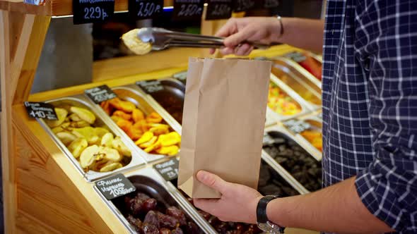 Grocery Shopper Buying Dried Fruit