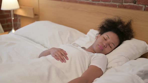 Relaxed African Woman Sleeping in Bed Peacefully