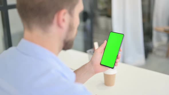 Young Creative Man Using Smartphone with Chroma Screen