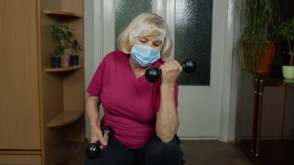 Senior Mature Grandmother Woman in Sportswear Doing Weightlifting Dumbbell Exercising at Home