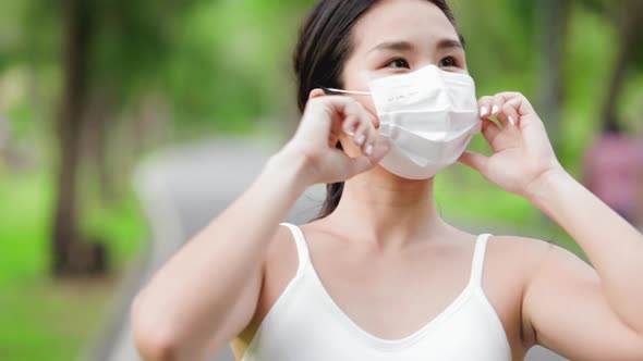 Asian runner jogging in the park during covid-19 pandemic.