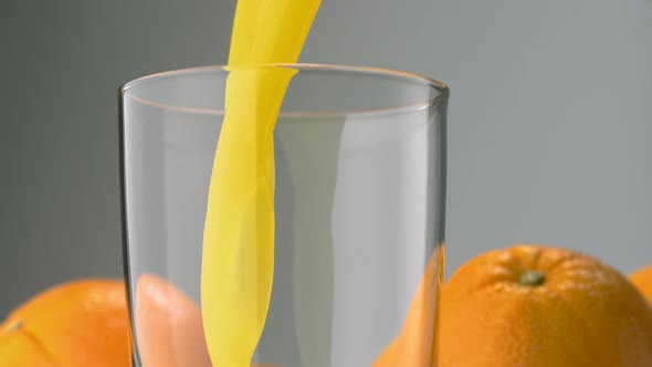 Pouring orange juice into glass, Slow Motion