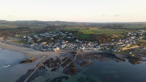 Marazion village on shore of Mount's Bay in Cornwall, UK. Aerial forward