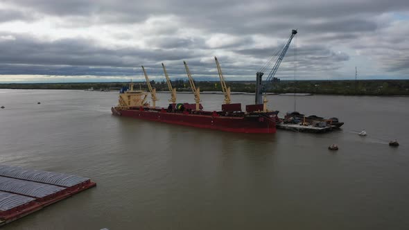 Aerial video of a ship being loaded on the Mississippi River in Louisiana