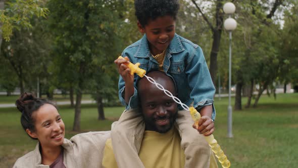 Happy Afro-American Family Walking Together in Park