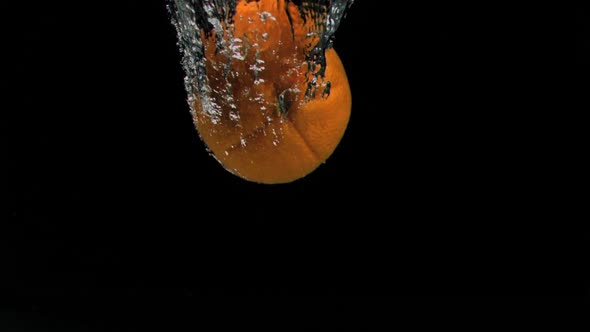 Orange diving in super slow motion into water