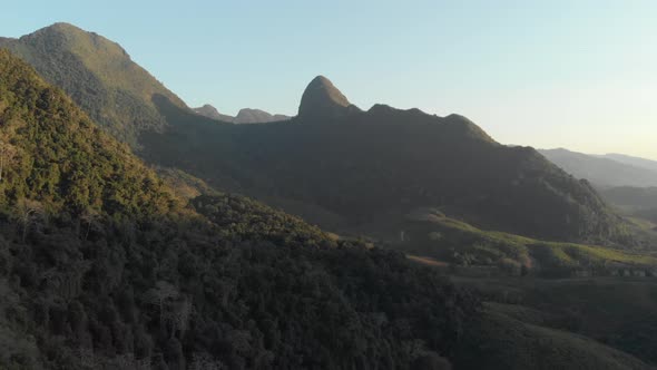 Aerial: flying over Nam Ou River Nong Khiaw Muang Ngoi Laos, sunset mountain landscape