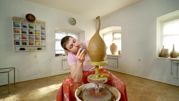 Experienced Potter Creating a Beautiful Clay Vase Using Professional Tools