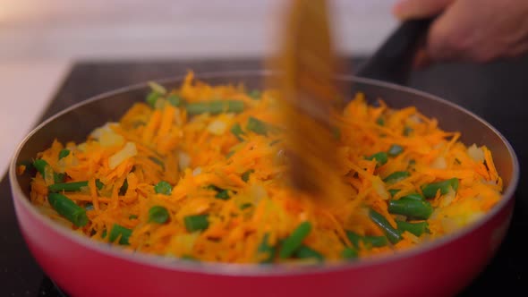Cooking Carrots and Green Beans in a Frying Pan Closeup