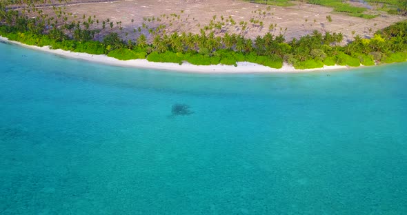 Tropical birds eye abstract shot of a white paradise beach and aqua blue water background in 4K