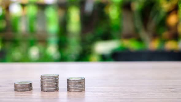 Money stack profit growth on wooden desk with bokeh background, increase investment and profits