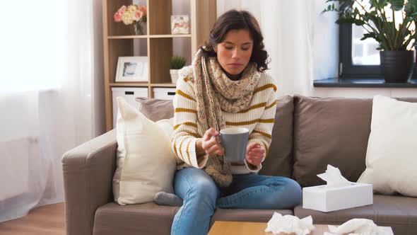 Sick Young Woman in Scarf Drinking Hot Tea at Home 14