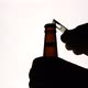 The Silhouette of Male hands opening brown beer bottle with opener - VideoHive Item for Sale