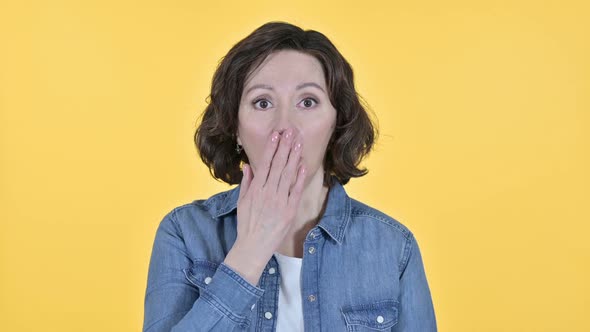 Shocked Expression By Old Woman on Yellow Background