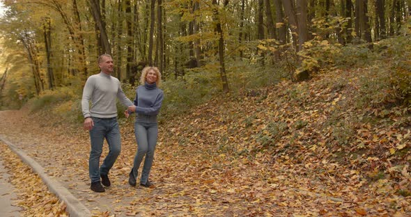 Loving Couple in Jeans on a Date in the Autumn Park