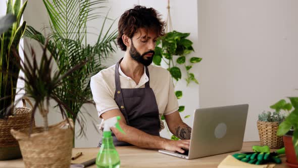 Small Business Entrepreneur Owner Male of Plant Shop Working on Laptop Computer