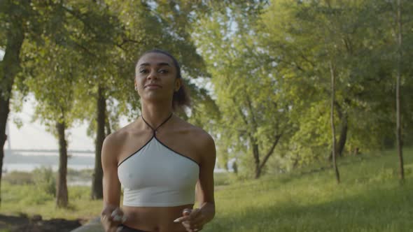 Running Woman Doing Cardio Workout in City Park