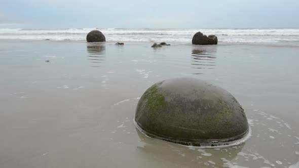 Moeraki Boulders in the Pacific Ocean Waves