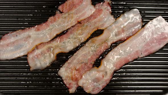 Frying Many Strips Of Bacon on a Grill