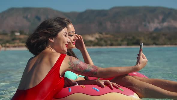 Two People Asian American Woman in Red Swimsuit Relaxing Refreshing Resting in Inflatable Swimming