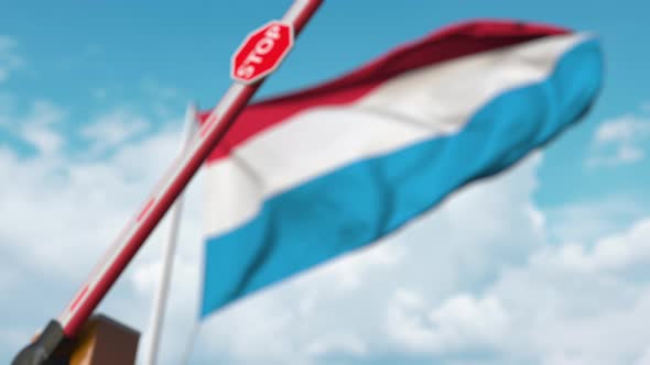 Barrier Gate Being Closed with Flag of Luxembourg As a Background