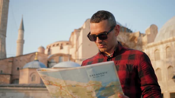 Man Tourist Looking at Map Against Ayasofya Mosque Travel Concept