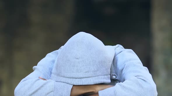 Depressed african-american guy wearing hood, suffering melancholy