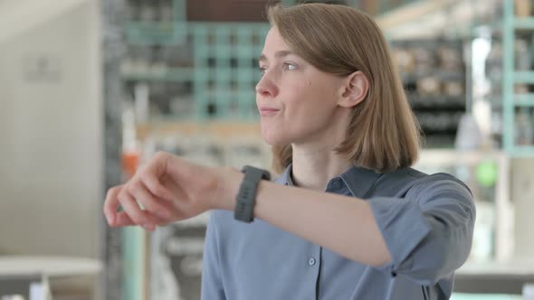 Portrait of Young Woman Checking Watch Waiting