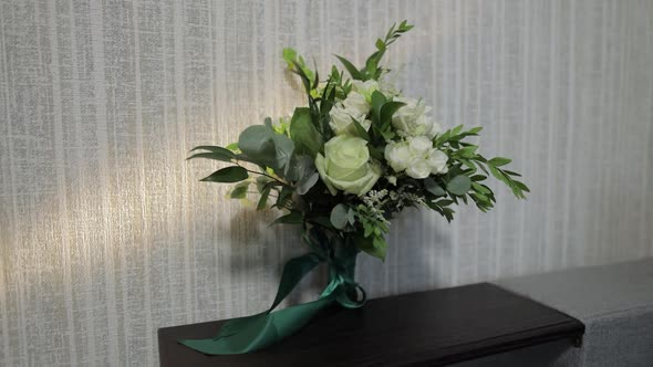 Bouquet of White Roses Flowers. Wedding Bouquet of Bride on Sofa. Morning Preparations of Newlyweds