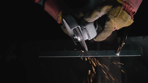 Close Up Details of Sparks, Industrial Worker Using Angle Grinder and Cutting Steel. Sparks Fly