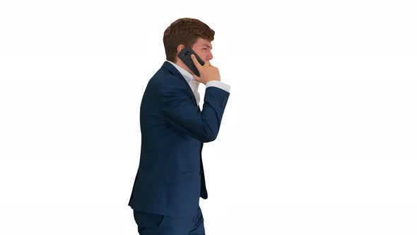 Handsome Young Businessman Talking on the Phone While Walking on White Background