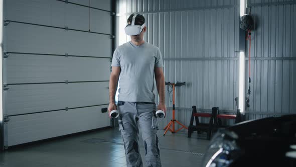 Male Mechanic in VR Headset Checking a Car