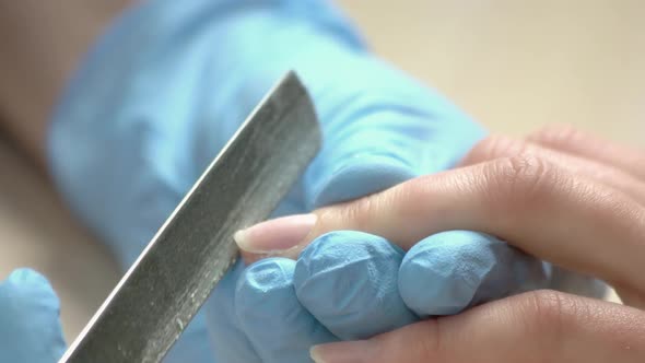 Beautician Filing Nail To Client Close Up.