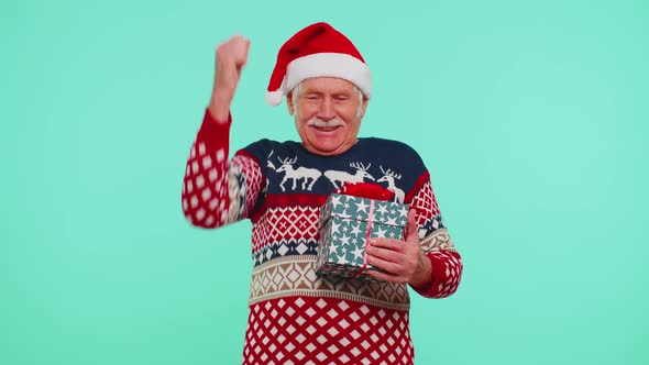 Grandfather Man in Sweater Santa Christmas Getting Present Gift Box Expressing Amazement Happiness