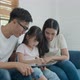 Happy asian family father mother and kid daughter sitting and using computer laptop technology - VideoHive Item for Sale