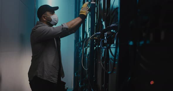 Man and Woman Fixing LED Display Together