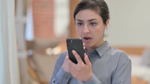 Portrait of Young Indian Woman Reacting to Loss on Smartphone